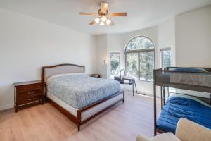 a bedroom with a bed and a ceiling fan at Serene Pine Mountain Club Home with Pool Access! in Pine Mountain Club