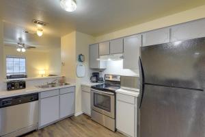 a kitchen with white cabinets and a stainless steel refrigerator at Quiet Killeen Townhome, 5 Mi to Fort Hood Shopping in Killeen
