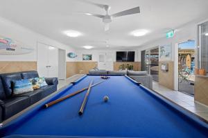 a pool table in a living room with a bill at Motel Sunshine Coast in Caloundra