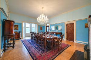 uma sala de jantar com uma mesa e cadeiras e um lustre em Historic Chambersburg Home with Pool and Game Rooms! em Chambersburg