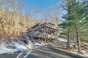a wooden house in the middle of a road at Rustic Getaway with Fireplace - Walk to Slopes! in Lyndhurst