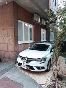 a white car parked in front of a building at Apartman City Peace Sarajevo, 72 m2, free parking in Sarajevo