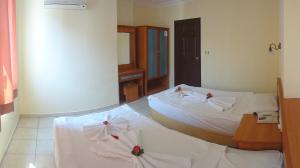 a hotel room with two beds with bows on them at Sailorson Apart Hotel in Alanya