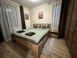 a bedroom with a large bed in a room at Petkovi Аpartments, Borovets Gardens - One-bedroom and Two-bedroom apartments in Borovets
