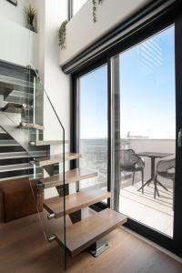 a glass staircase in a house with a view at SIGMA Luxury Apartments & Suites in Thessaloniki