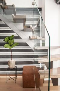 a staircase with a plant in a room at SIGMA Luxury Apartments & Suites in Thessaloniki
