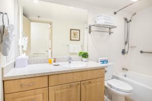 a bathroom with a sink and a toilet and a tub at Cozy & Diamond Head View at Waikiki with Parking in Honolulu