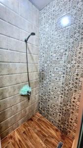 a bathroom with a shower with a stone wall at F2 Haut-standing millenium in Bir el Djir