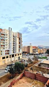 a city with tall buildings and a parking lot at F2 Haut-standing millenium in Bir el Djir