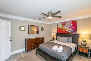 a bedroom with a bed and a ceiling fan at High Rise Downtown Condo With Skyline View in Atlanta