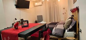 a bedroom with a large bed with a red table at il Cortiletto 2 apartments in Calolziocorte