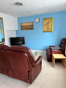 a living room with a couch and a chair and a tv at semi-detach in Saint Helens