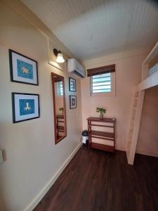 a room with a staircase and a mirror on a wall at Lazy Guesthouse in Vieques