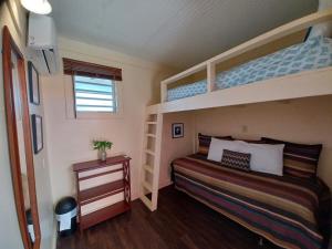 1 Schlafzimmer mit 2 Etagenbetten und einem Tisch in der Unterkunft Lazy Guesthouse in Vieques