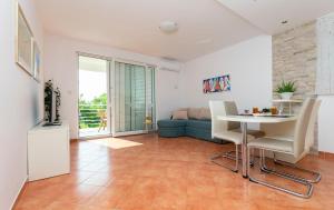 a living room with a table and a couch at Apartments Olive sea view in Mimice
