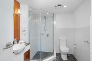 a bathroom with a shower and a toilet and a sink at Ocean Views at Surfers Paradise - Chevron Renaissance - 2 Bedroom Apartment - Wow Stay in Gold Coast