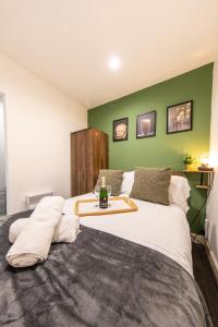 a bedroom with a large bed with a tray on it at Peaceful one bed flat in Stockport centre in Stockport