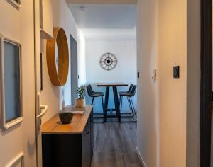 a hallway with a table and chairs in a room at La Casa de Hugo in Colmar