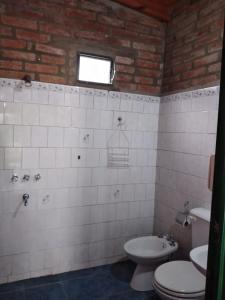 a bathroom with a toilet and a sink at La Vuelta del Río in Panaholma