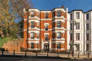 a large red brick building on a city street at Stylish flat in Hampstead in London