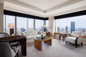 a living room with a couch and a table at The Ritz-Carlton, Tokyo in Tokyo