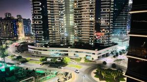 an aerial view of a city at night with buildings at Bachelor Partition Room in Tecom in Dubai