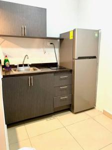 a kitchen with a stainless steel refrigerator and a sink at Departamento Regiomontano in Monterrey