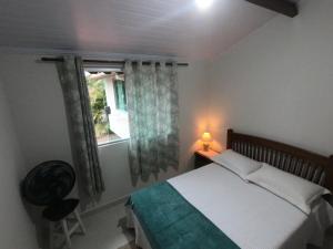 Postel nebo postele na pokoji v ubytování Recanto Guarassol Apartamentos