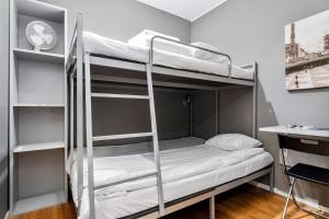 a room with two bunk beds and a desk at Sure Hotel by Best Western Stockholm Alvsjo in Stockholm