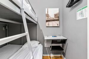a bedroom with a bunk bed and a desk at Sure Hotel by Best Western Stockholm Alvsjo in Stockholm
