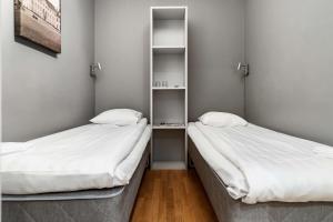 two beds sitting next to each other in a room at Sure Hotel by Best Western Stockholm Alvsjo in Stockholm