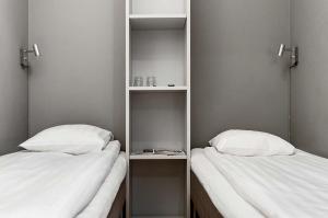 two beds sitting next to each other in a room at Sure Hotel by Best Western Stockholm Alvsjo in Stockholm