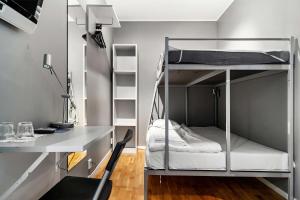 a room with a desk and bunk beds at Sure Hotel by Best Western Stockholm Alvsjo in Stockholm