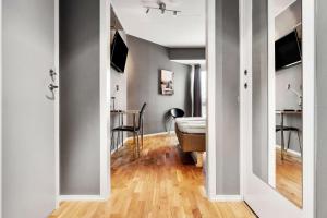 a hallway with a room with a bed and a table at Sure Hotel by Best Western Stockholm Alvsjo in Stockholm