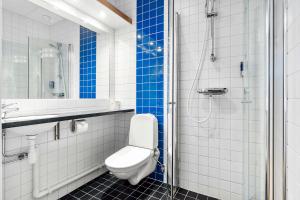 a bathroom with a toilet and a sink and a shower at Sure Hotel by Best Western Stockholm Alvsjo in Stockholm