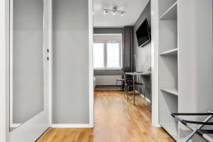 a hallway with a room with a desk and a television at Sure Hotel by Best Western Stockholm Alvsjo in Stockholm