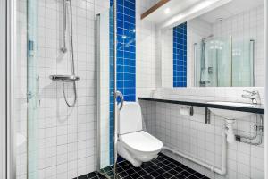 a bathroom with a toilet and a glass shower at Sure Hotel by Best Western Stockholm Alvsjo in Stockholm