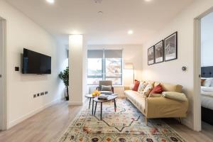 a living room with a couch and a table at Lotus - Sleeps 5 in Bracknell