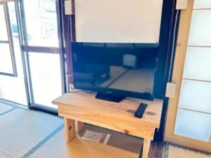 a television sitting on a table in a room at Potato mura house tatara - Vacation STAY 90000v in Nagano