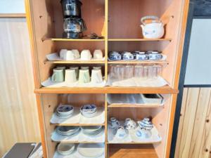 a cabinet filled with lots of dishes and shoes at Potato mura house tatara - Vacation STAY 90000v in Nagano