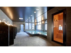 a large bathroom with a tub in the middle at Welina Hotel Premier Nakanoshima West - Vacation STAY 22043v in Osaka