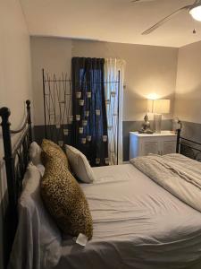 a bedroom with a cheetah laying on a bed at CHATHAM TERRACE LAKE HOUSE in Bridgeport