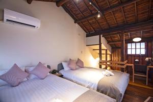 - une chambre avec 2 lits dans une pièce dotée de plafonds en bois dans l'établissement Tabitaimu-Sumiyoshiharesora - Vacation STAY 15843, à Osaka