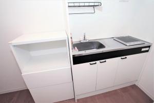 a small white kitchen with a sink and a counter at Numero Uno Tokyo - Vacation STAY 25720v in Tokyo