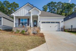 a large white house with a garage at Citrus Cottage: Comfy - Hwy 10 - Peaceful Retreat in Tallahassee