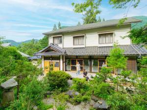 a house with people walking in front of it at Gonomori main building - Vacation STAY 24252v in Nagano