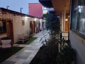 a courtyard of a building with lights and plants at HOSTAL LA MODERNA in Quintero