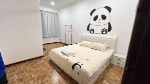 a bedroom with a bed with a panda sticker on the wall at PandaHomestay28 in Skudai