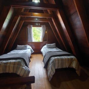 מיטה או מיטות בחדר ב-ALPINO DEL BOSQUE