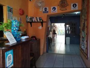 an entrance to a restaurant with a counter and a hallway at Hostel Casa Xtakay in Valladolid